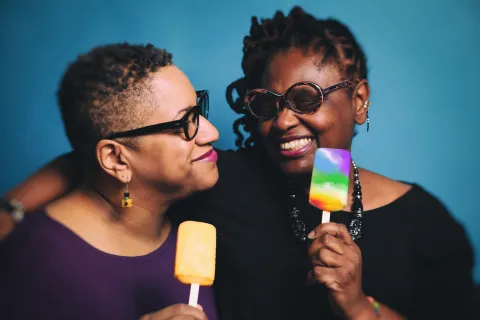 a gay couple eating popsicles